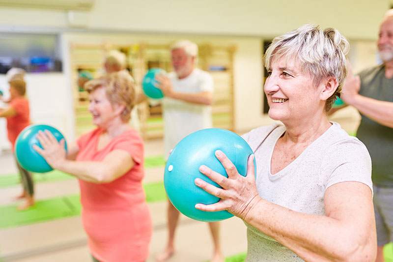 Seniors doing rehab exercises in a nursing home or assisted living facility near leland, nc