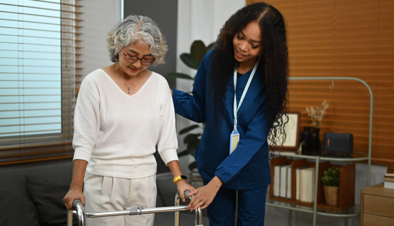 A Caregiver Helps Patient With Inpatient Joint Rehabilitation