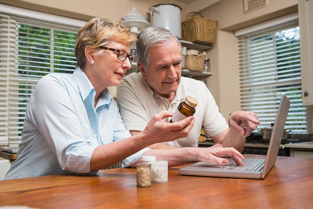 A Senior Couple Using a Laptop to Look up Medicine Interactions at a Kitchen Table Drug Interactions in Older Adults